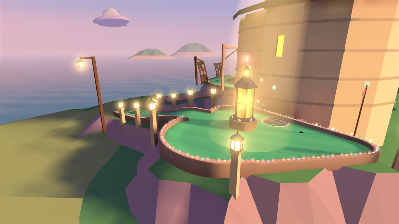 A heart-shaped green ringed with lanterns beside the lighthouse